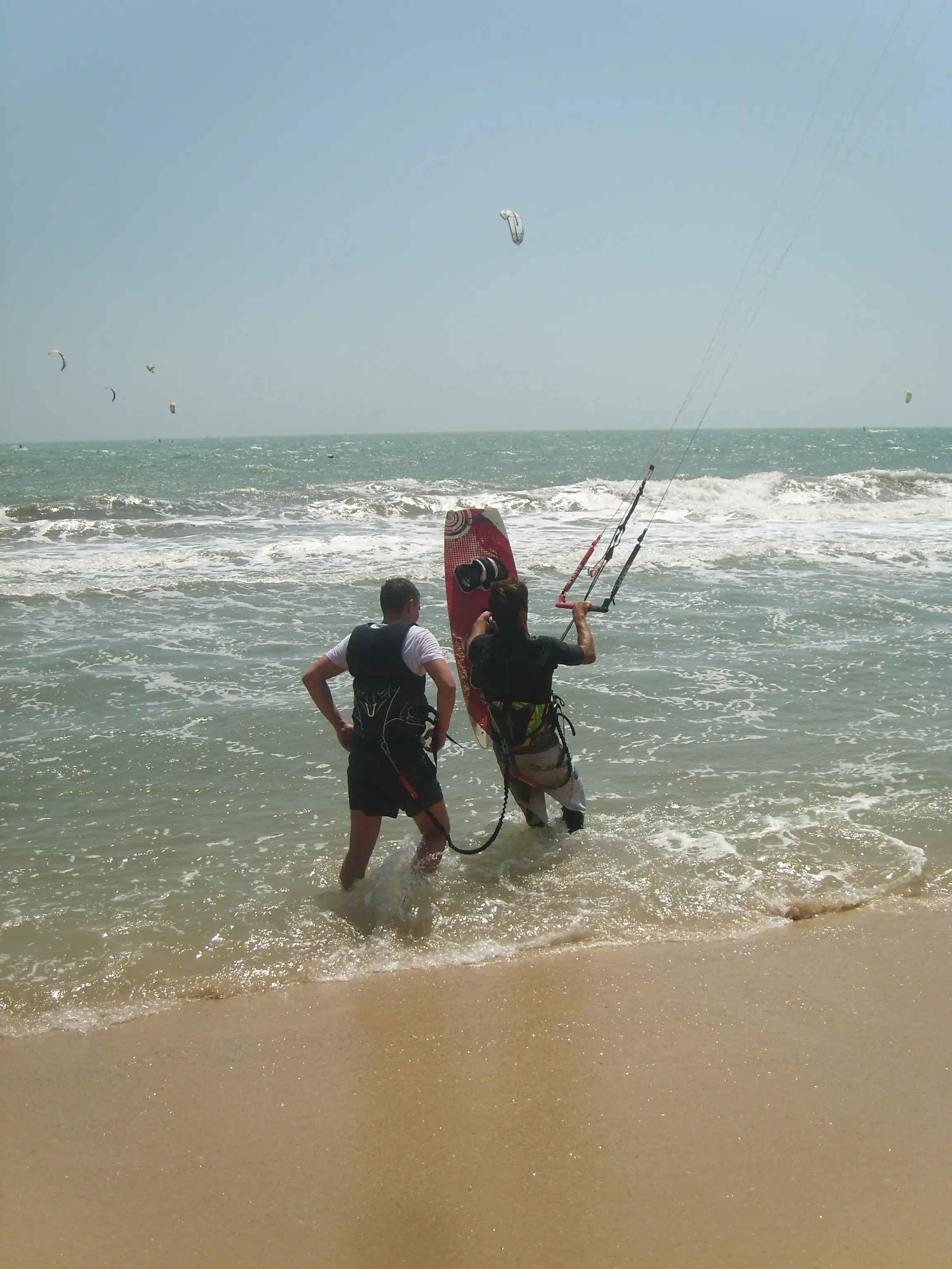 Kitesurfing instructor with student on the beach