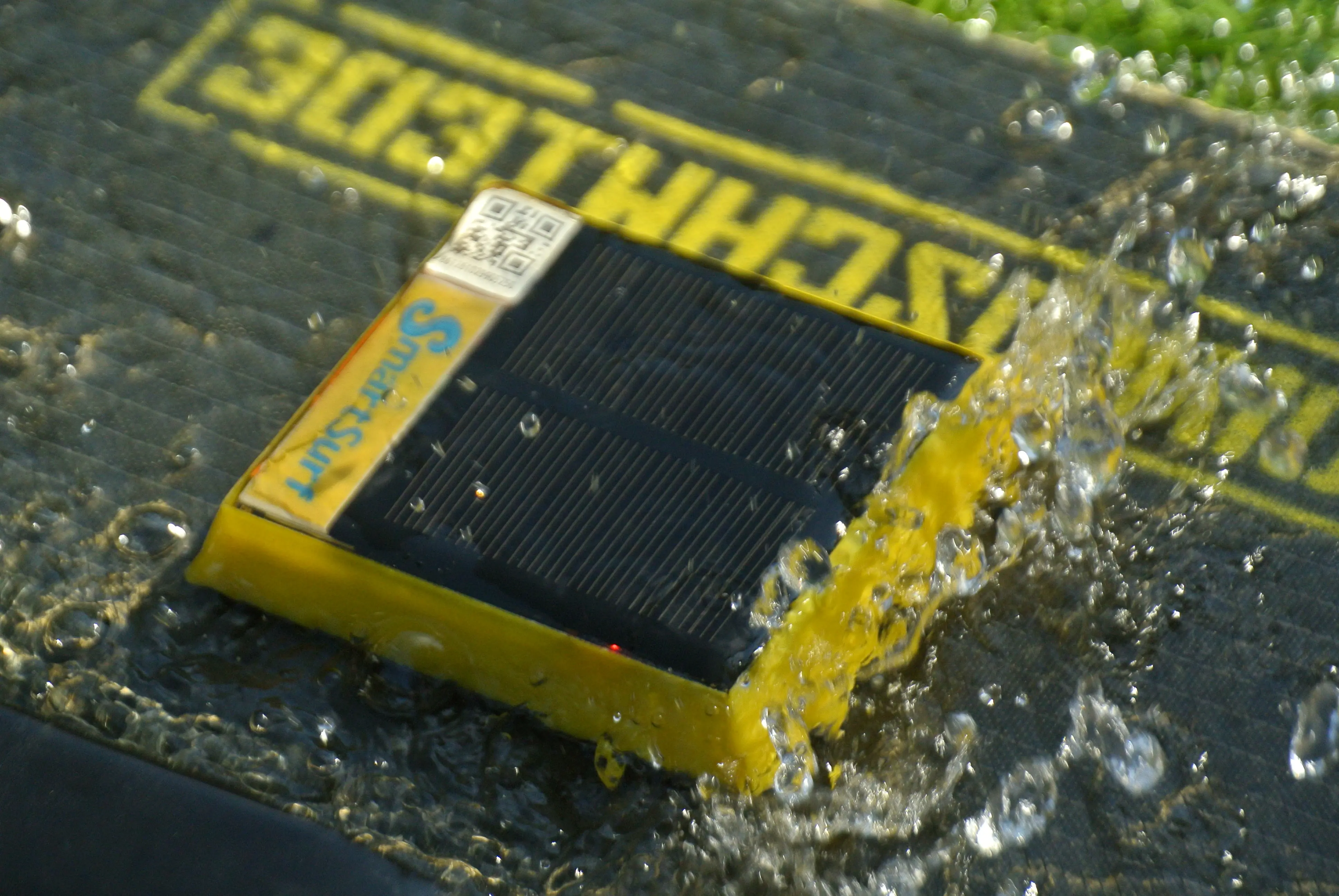 SmartSurf device being splashed with water on a kiteboard